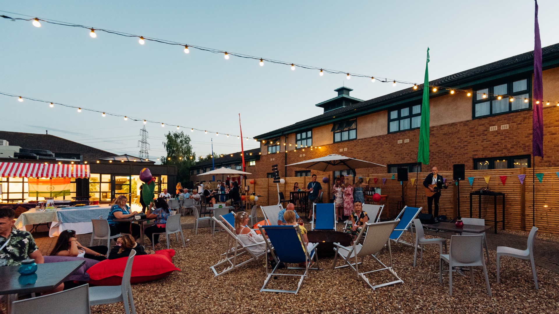 outdoor evening party with people and string lights