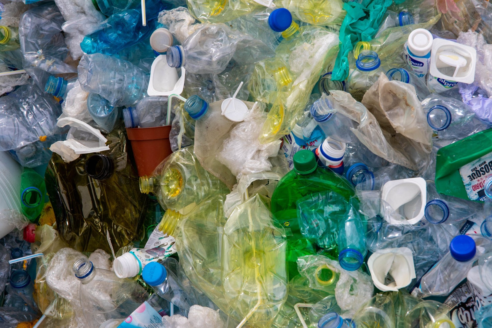 pile of discarded plastic bottles containers and packaging waste