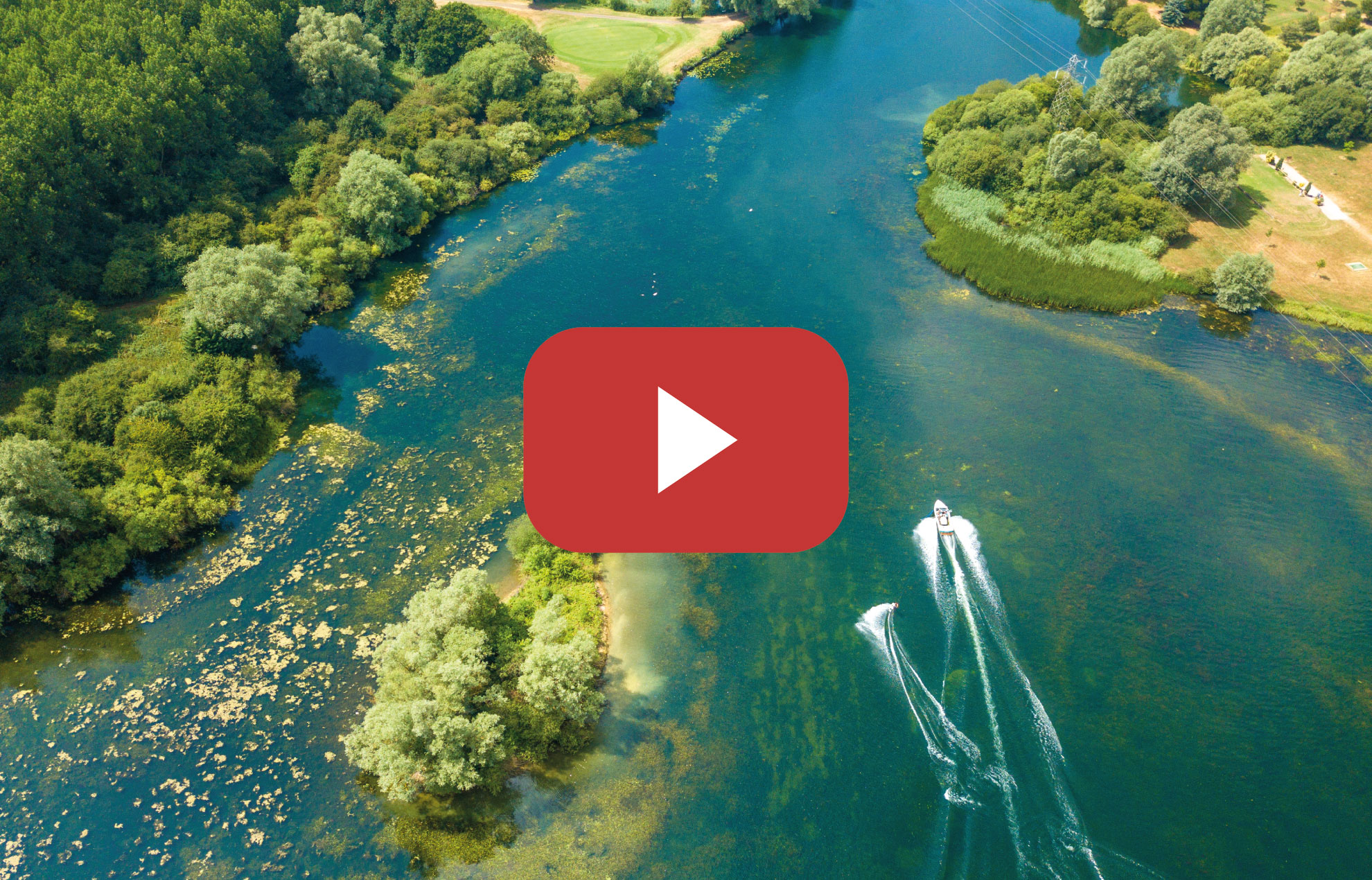 aerial view of boat towing water skier on river
