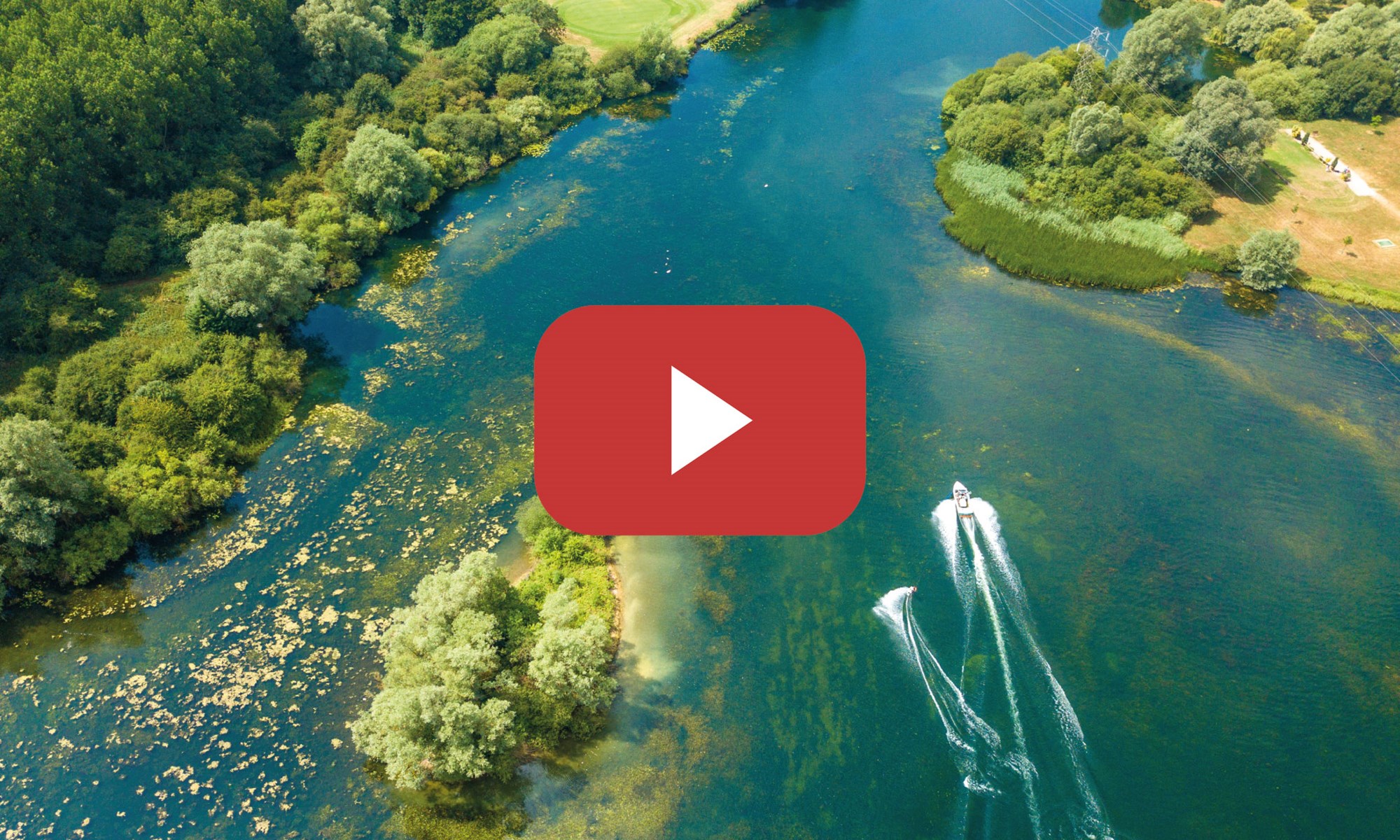 aerial view of boat towing water skier on river