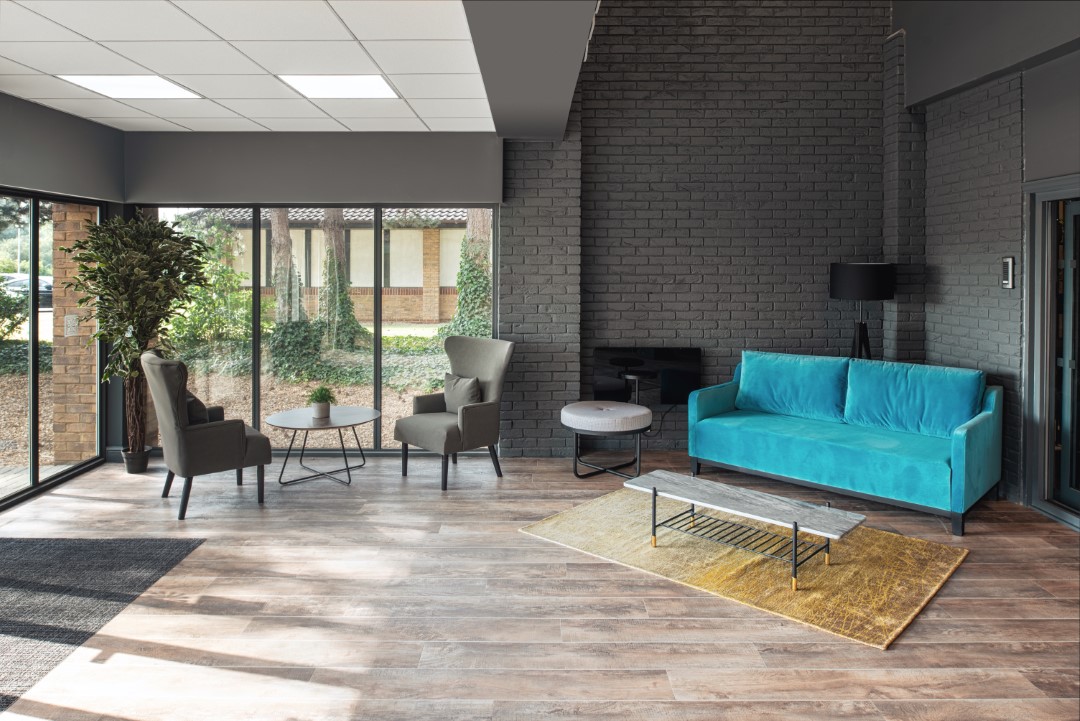 modern sitting area with blue sofa and large windows