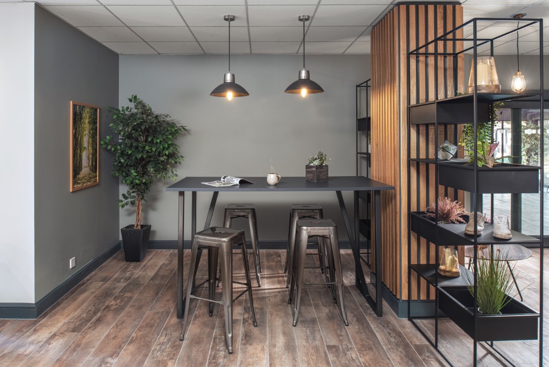 modern dining area with black stools and plants