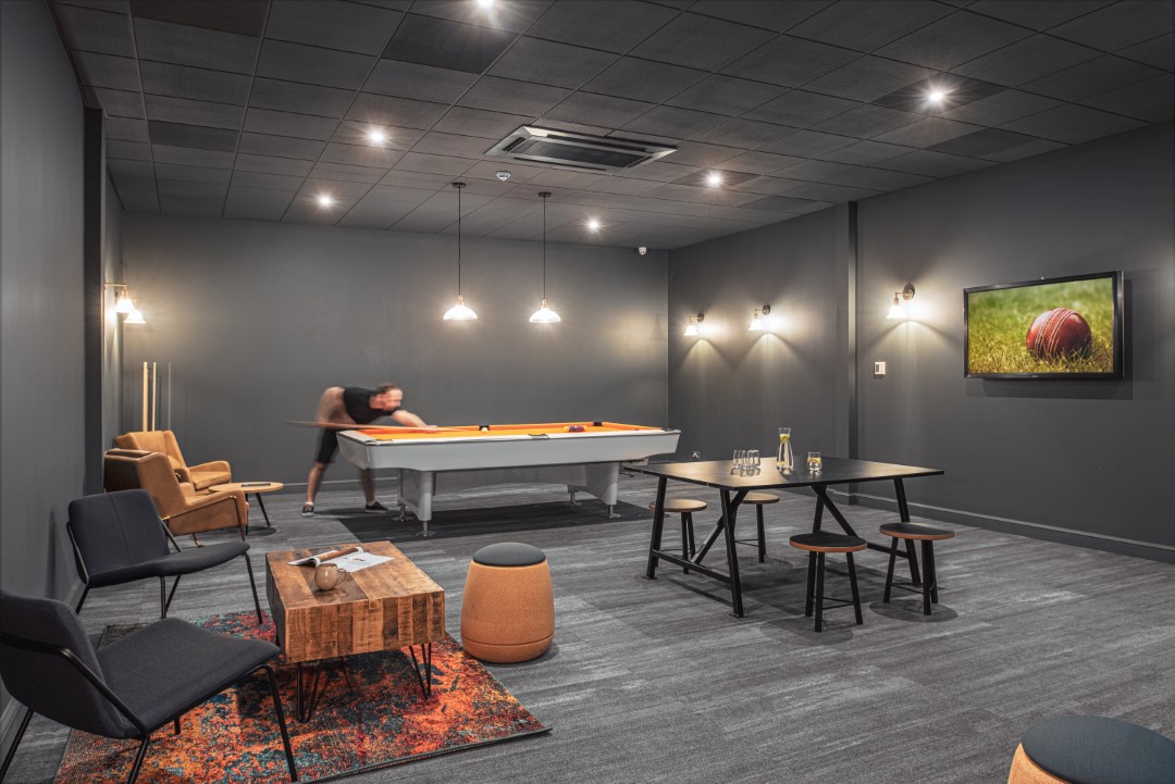 modern games room with pool table and seating