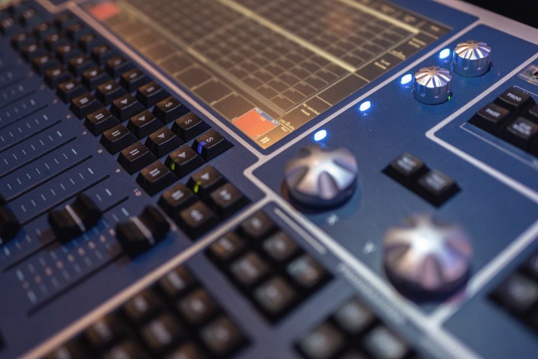 audio mixing console with buttons and knobs