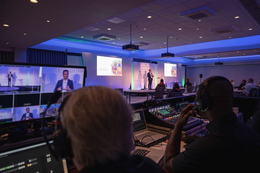 conference presentation with technicians in control room
