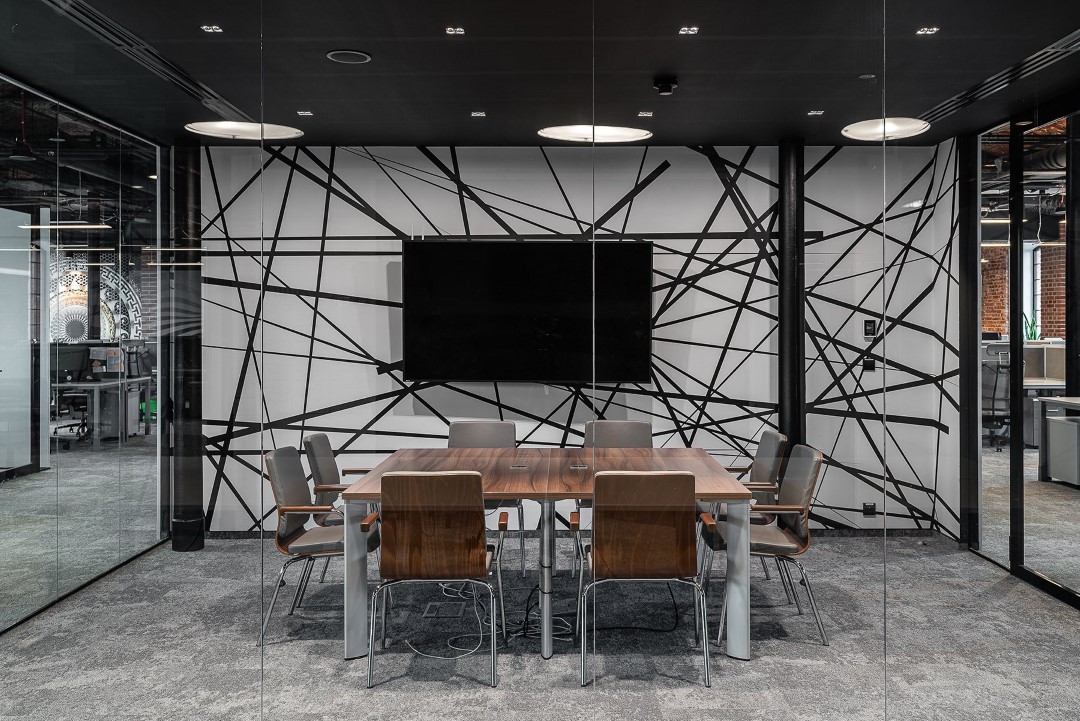 modern glass walled office meeting room with television