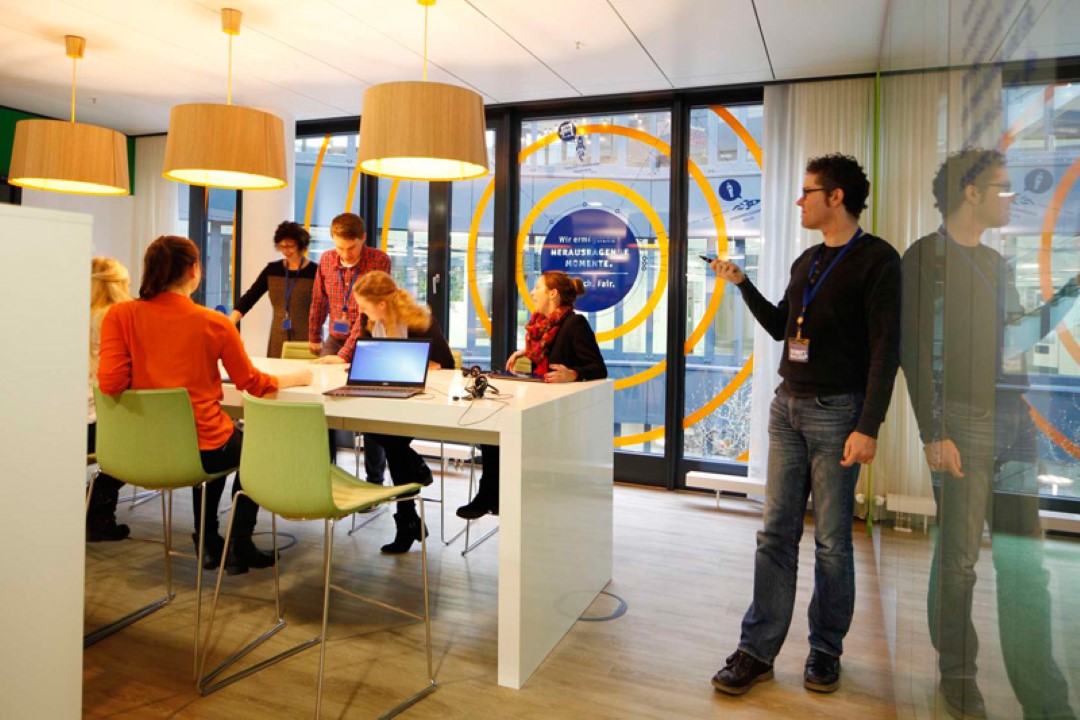 people working together around table in modern office