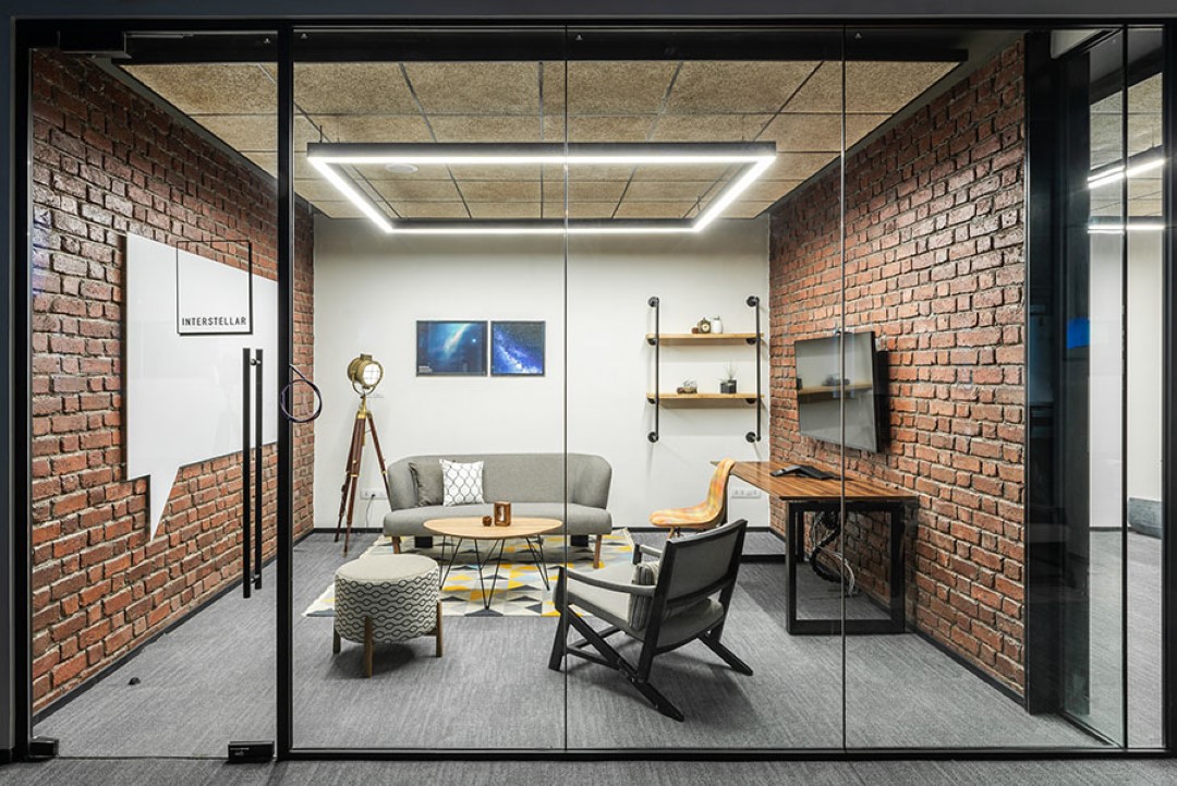 modern glass office room with brick walls and furniture