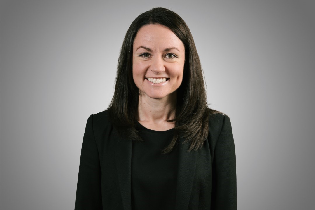 smiling woman with dark hair wearing black jacket