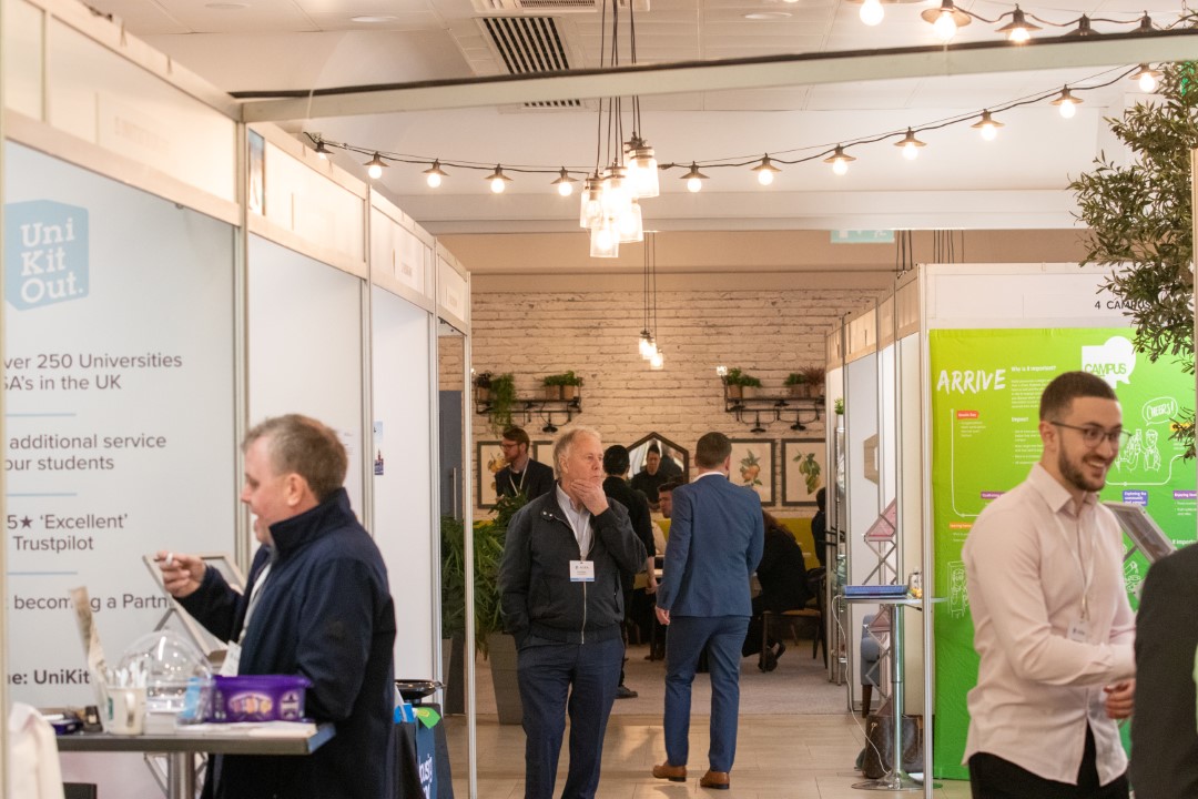 people talking at an indoor exhibition or fair
