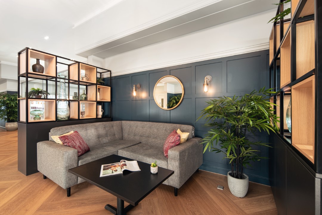 grey corner sofa with cushions and black table