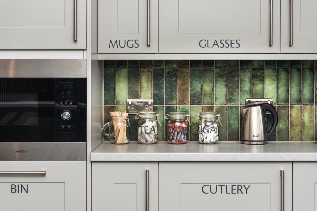 kitchen counter with jars and electric kettle