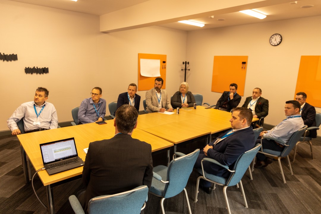 people sitting around table in meeting room
