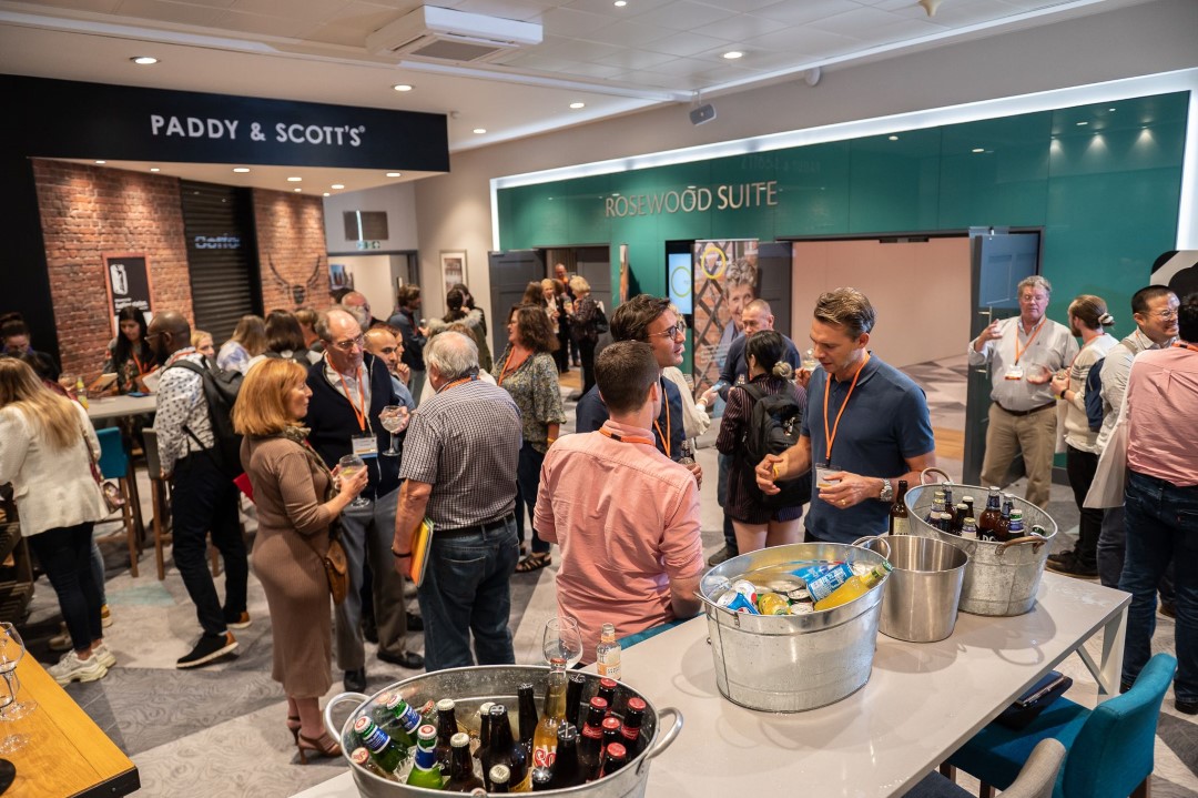 people socialising at indoor networking event with drinks