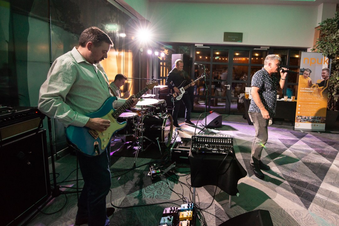 band performing live indoors with guitarist and singer