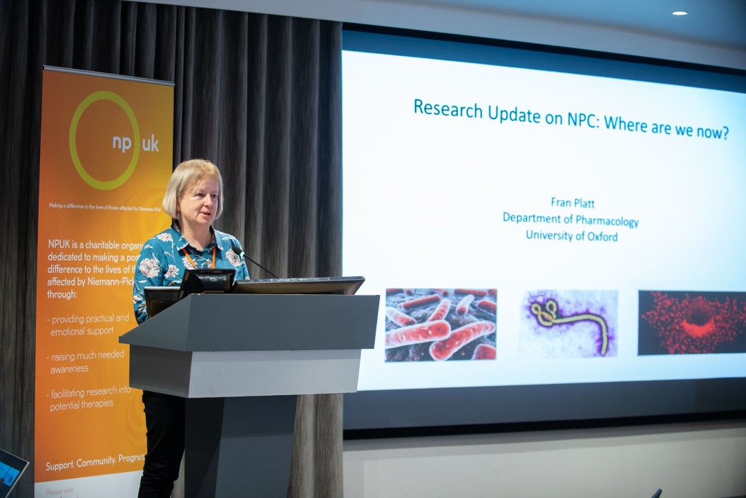 woman giving a medical research presentation at conference