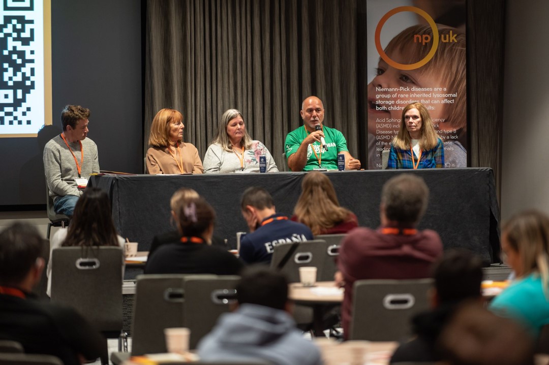 panel discussion with five people speaking to an audience