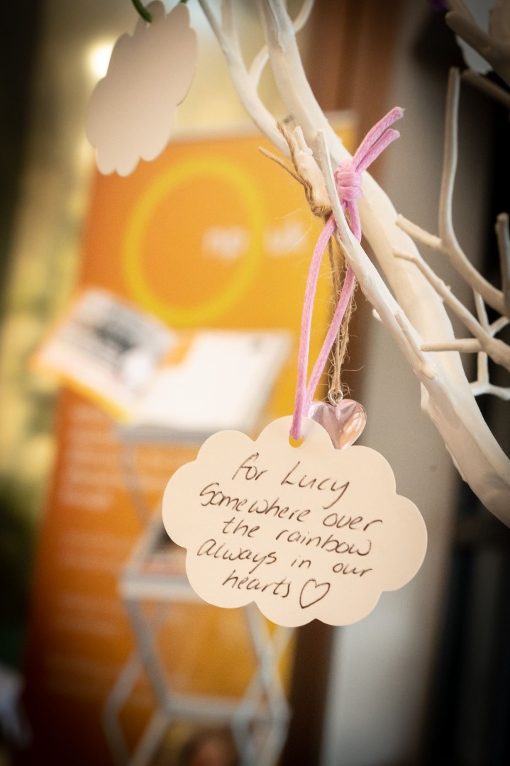 handwritten note hanging on white tree branch