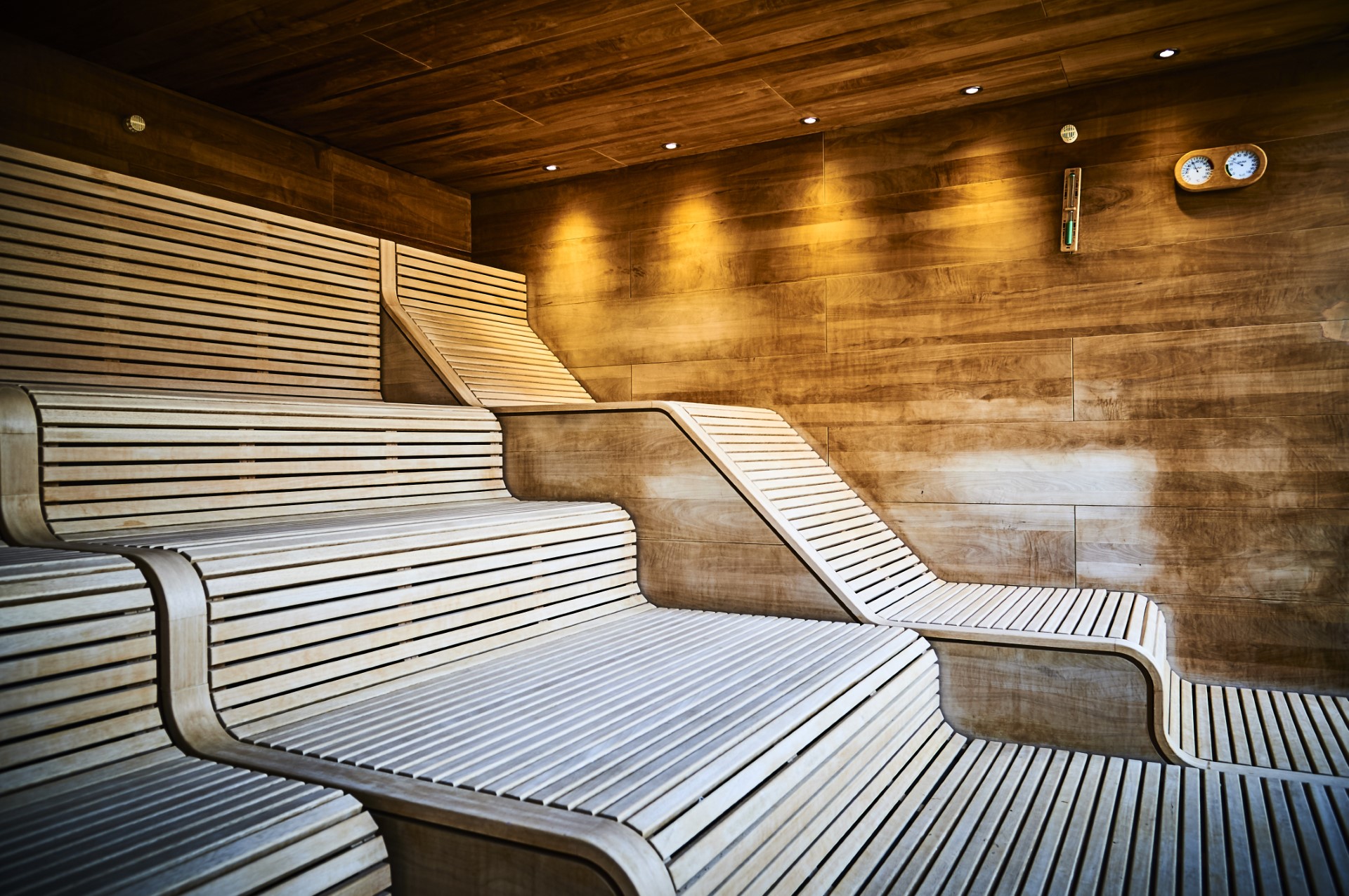 interior of wooden sauna room with tiered benches