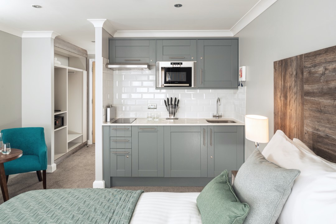 modern studio room with kitchenette and bed