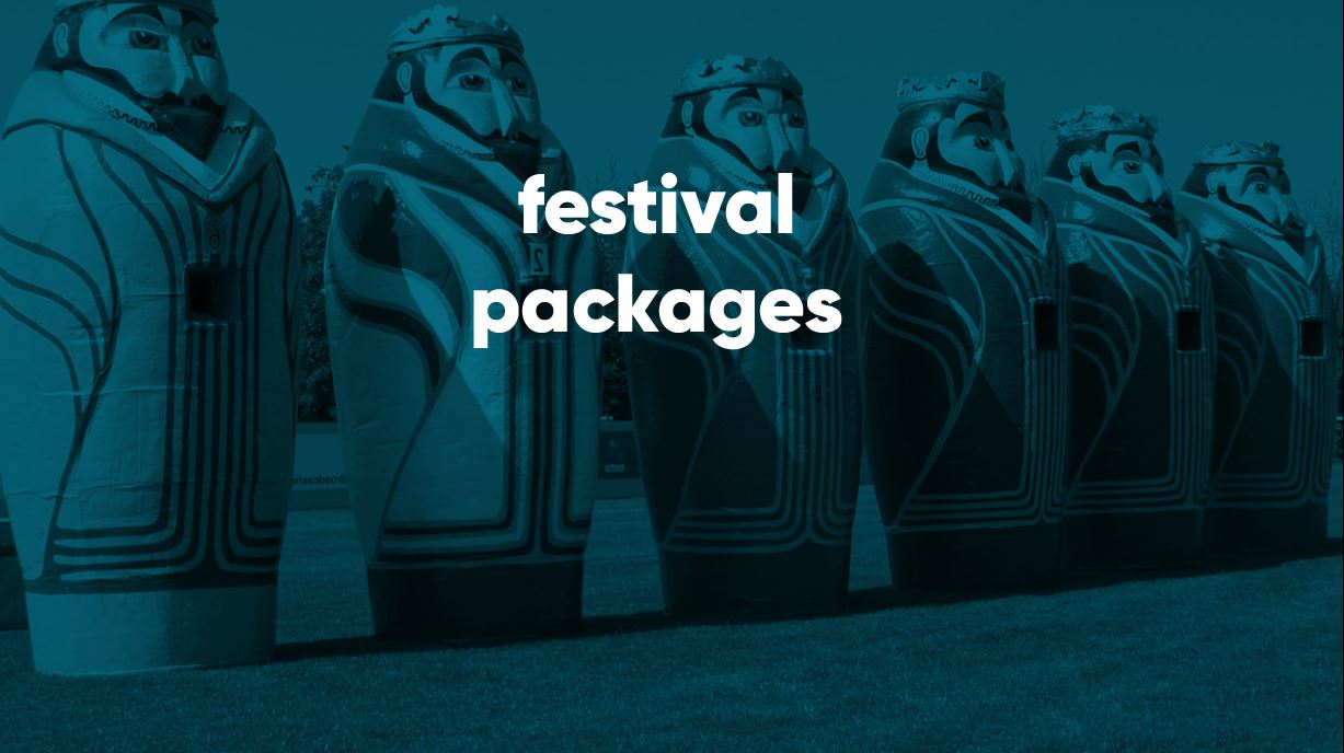 large painted king statues lined up on grass