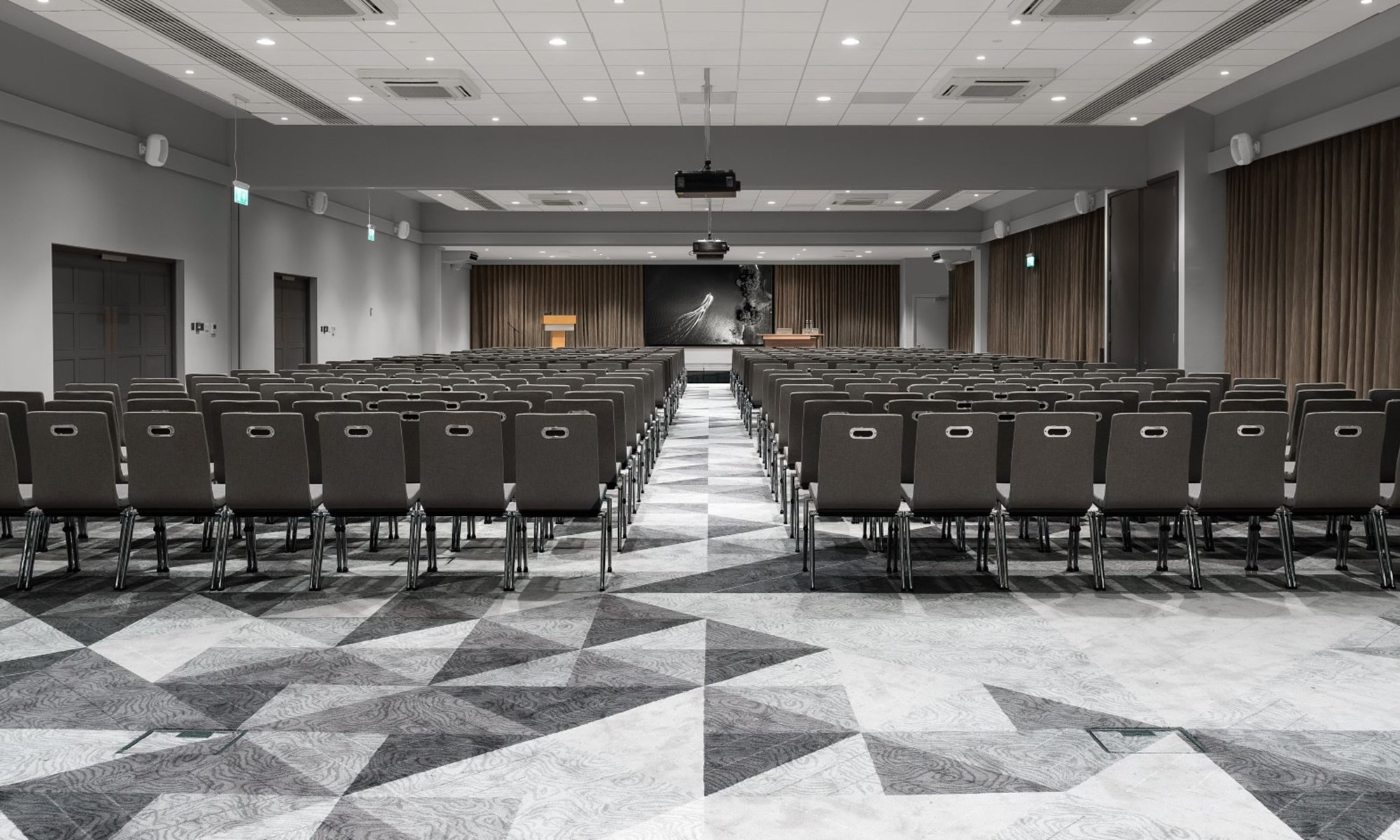empty conference room with rows of chairs and podium