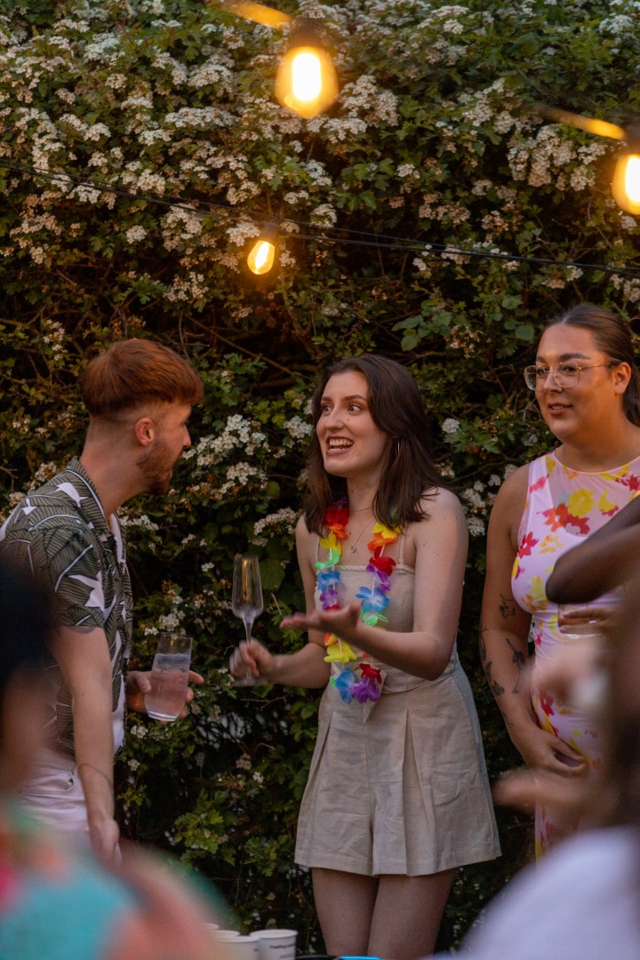 young people talking with drinks and flowers