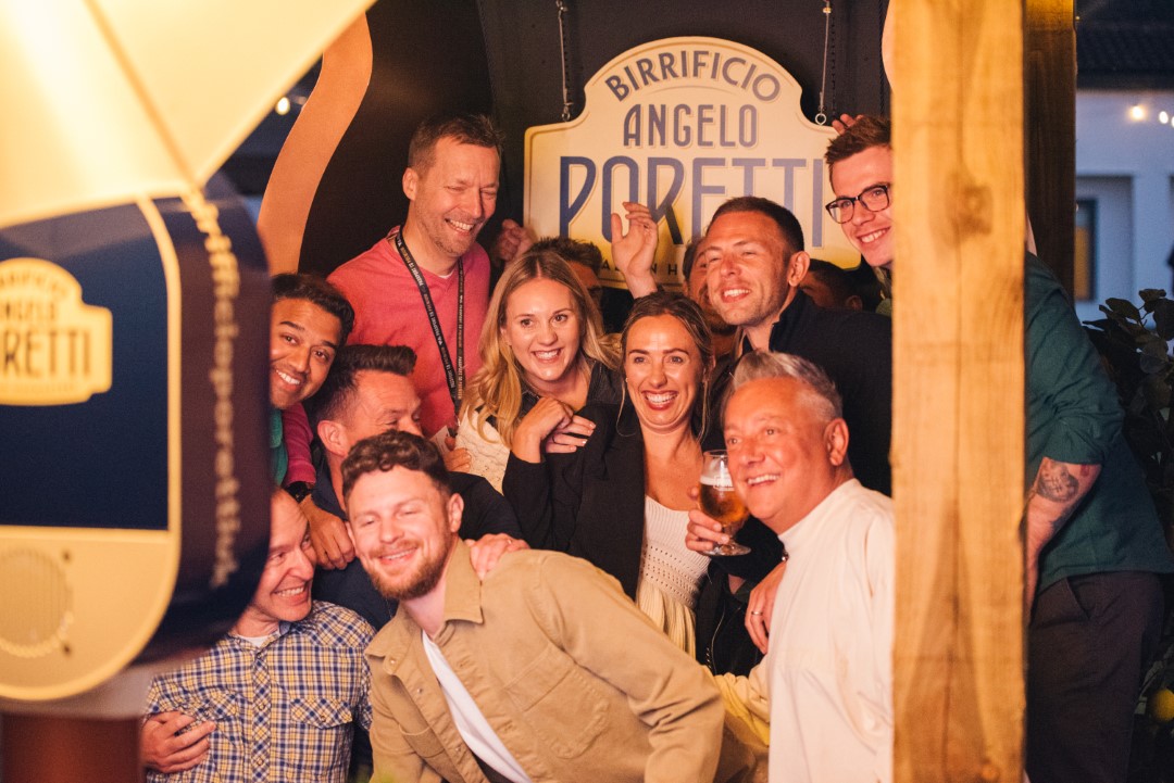 group of friends smiling in bar with beer