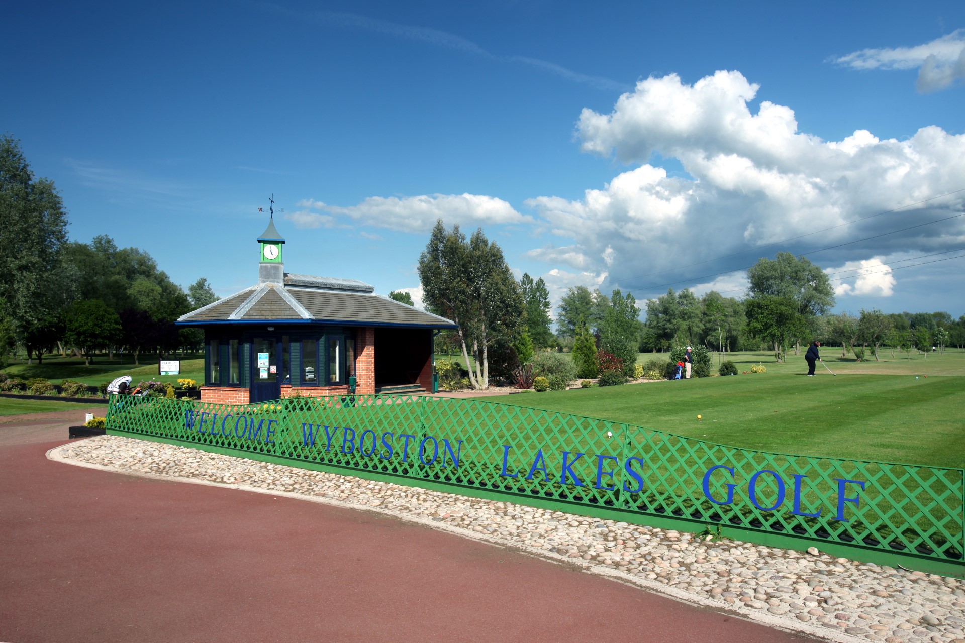 golf course with small building and players on green