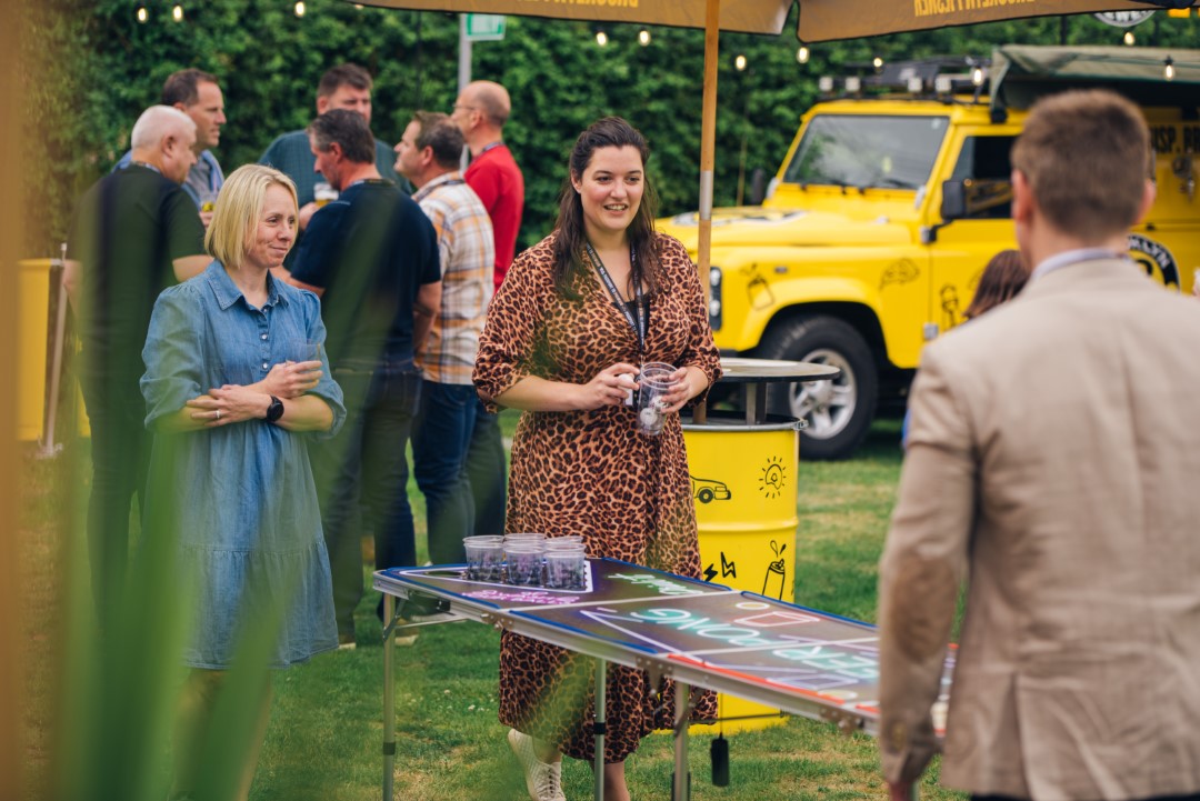 people playing table game at outdoor social event