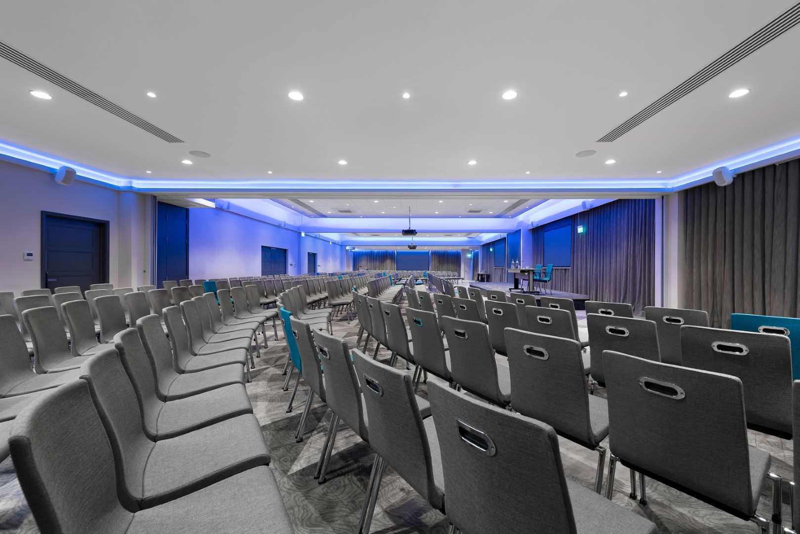 empty conference room with grey chairs and blue lighting
