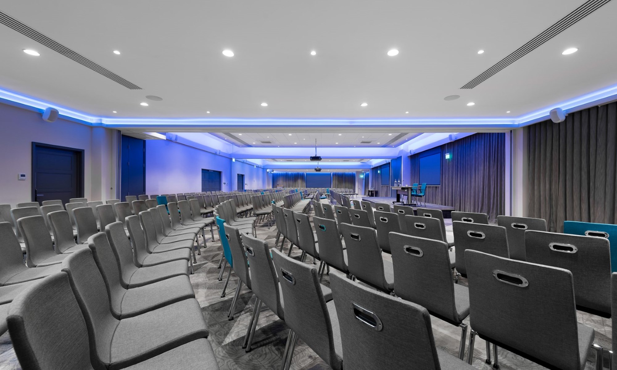 empty conference room with grey chairs and blue lighting