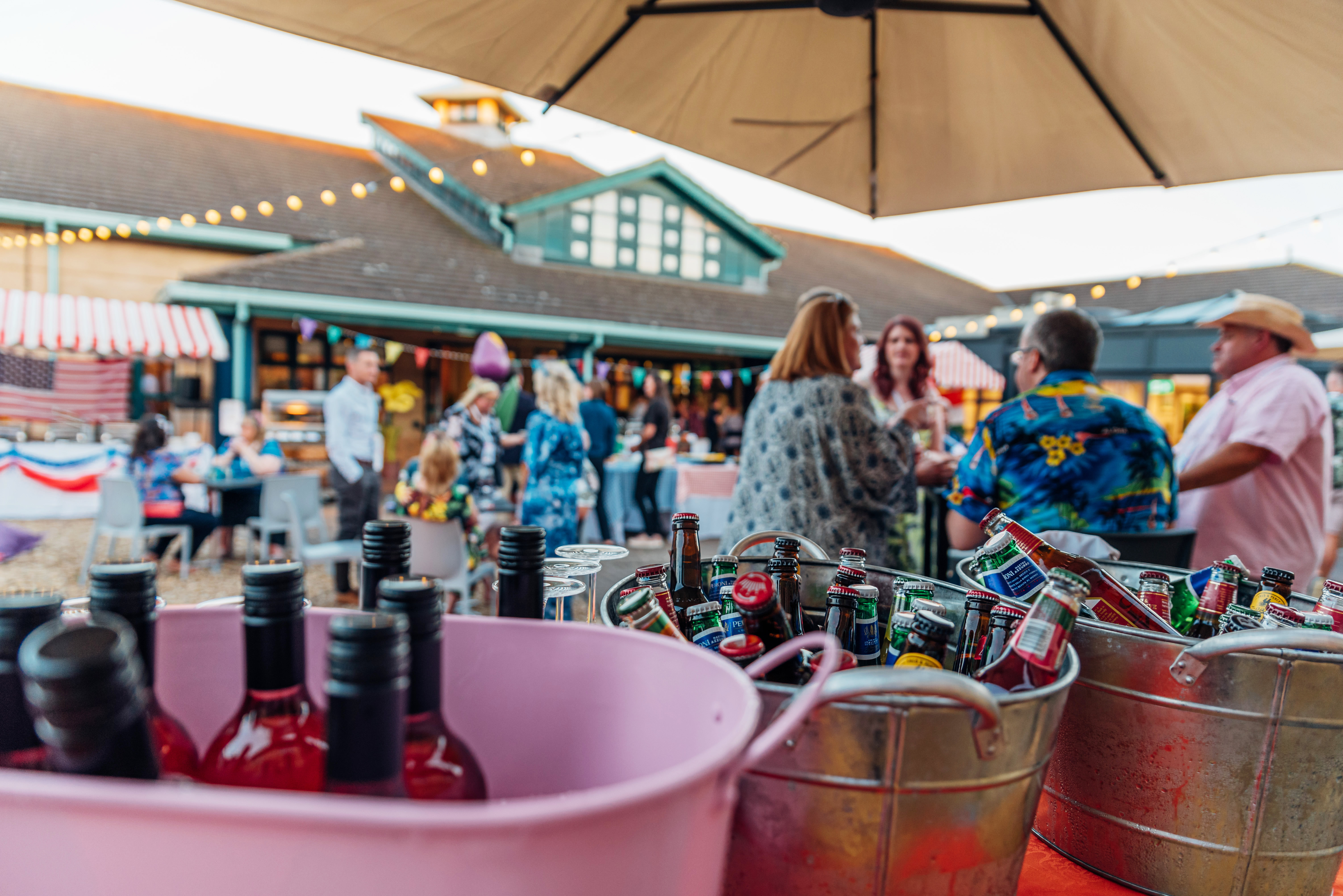 buckets of drinks at outdoor summer party with people