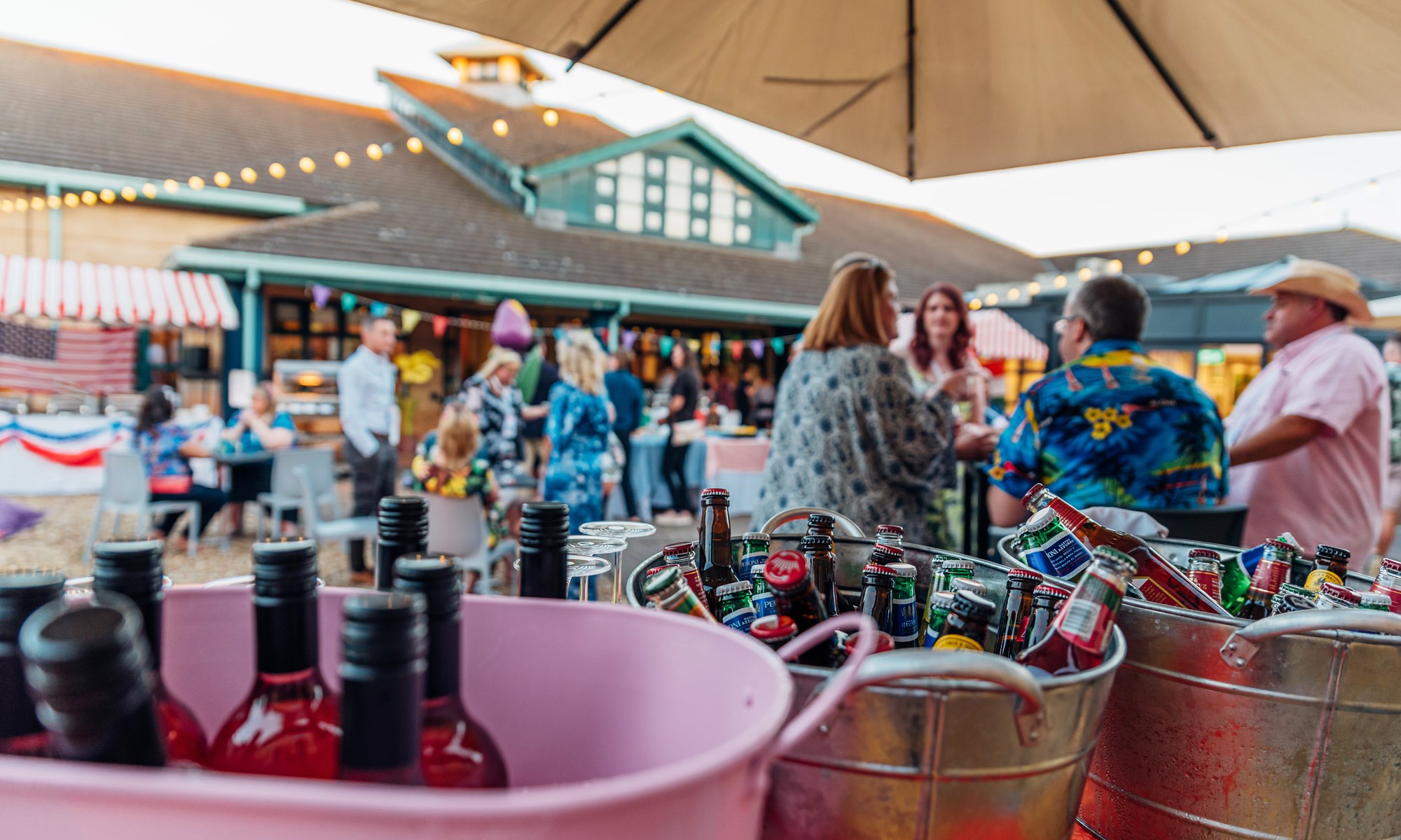 buckets of drinks at outdoor summer party with people