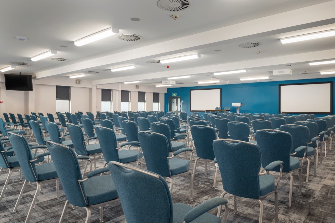 empty conference room with blue chairs and projection screens