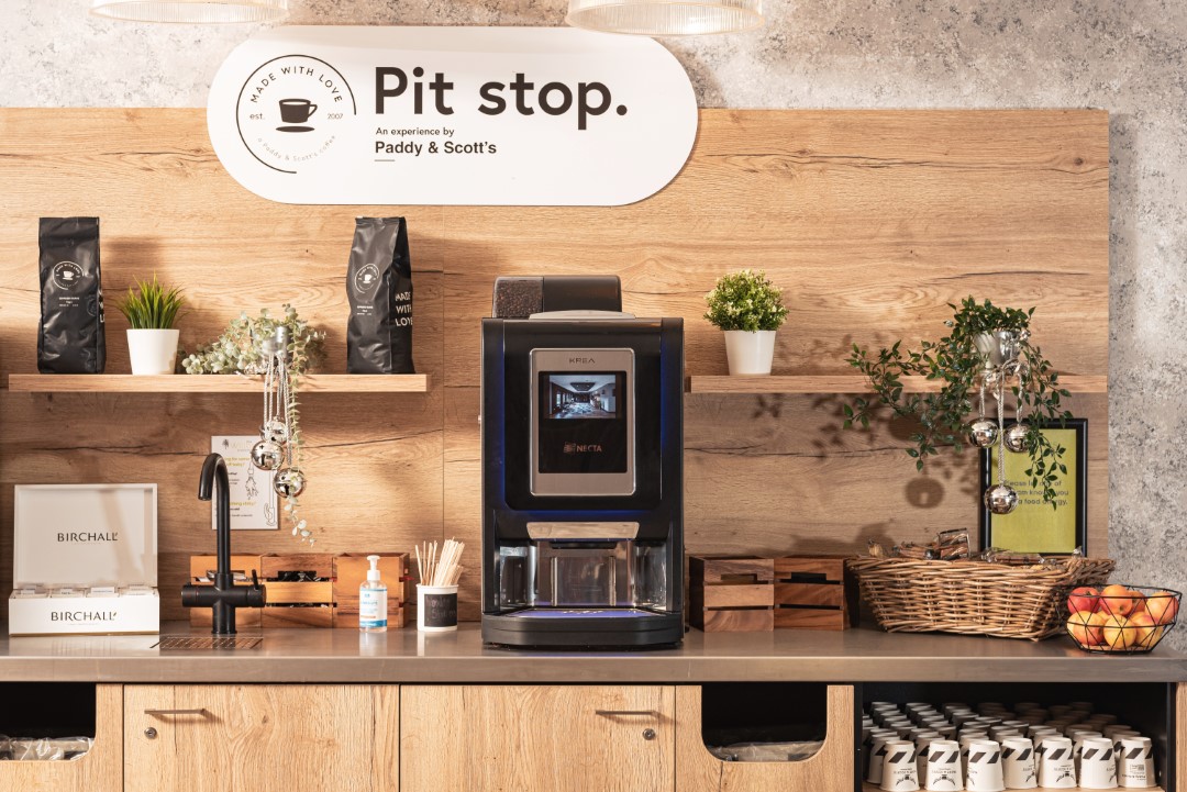 coffee station with machine plants and fruit bowl