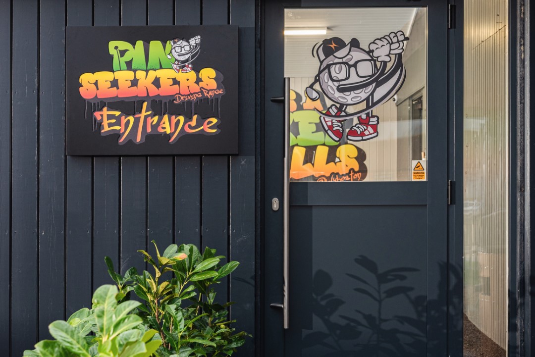 mini golf entrance with colourful sign and cartoon character