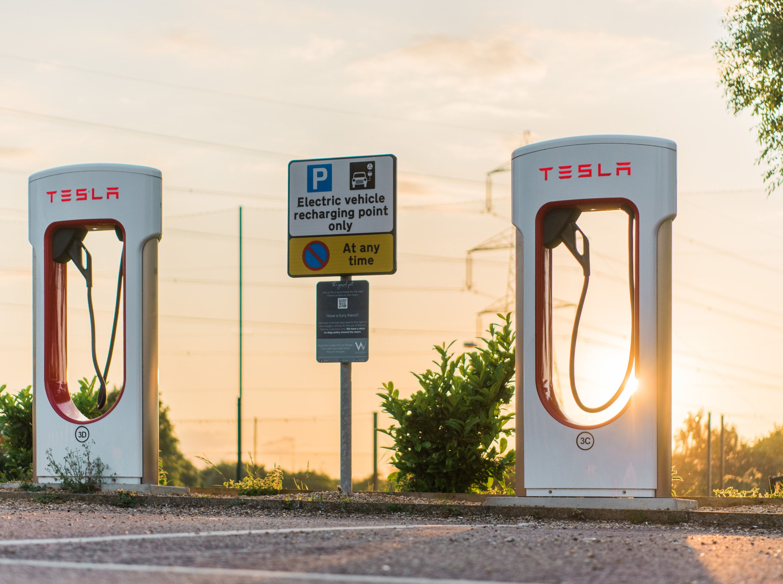 two electric car charging points at sunset