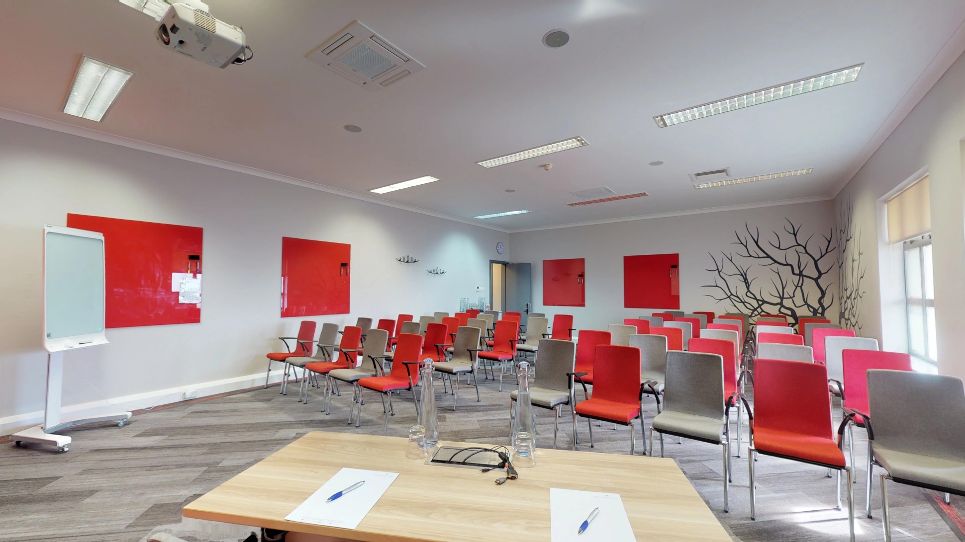 empty training room with red and grey chairs and whiteboard