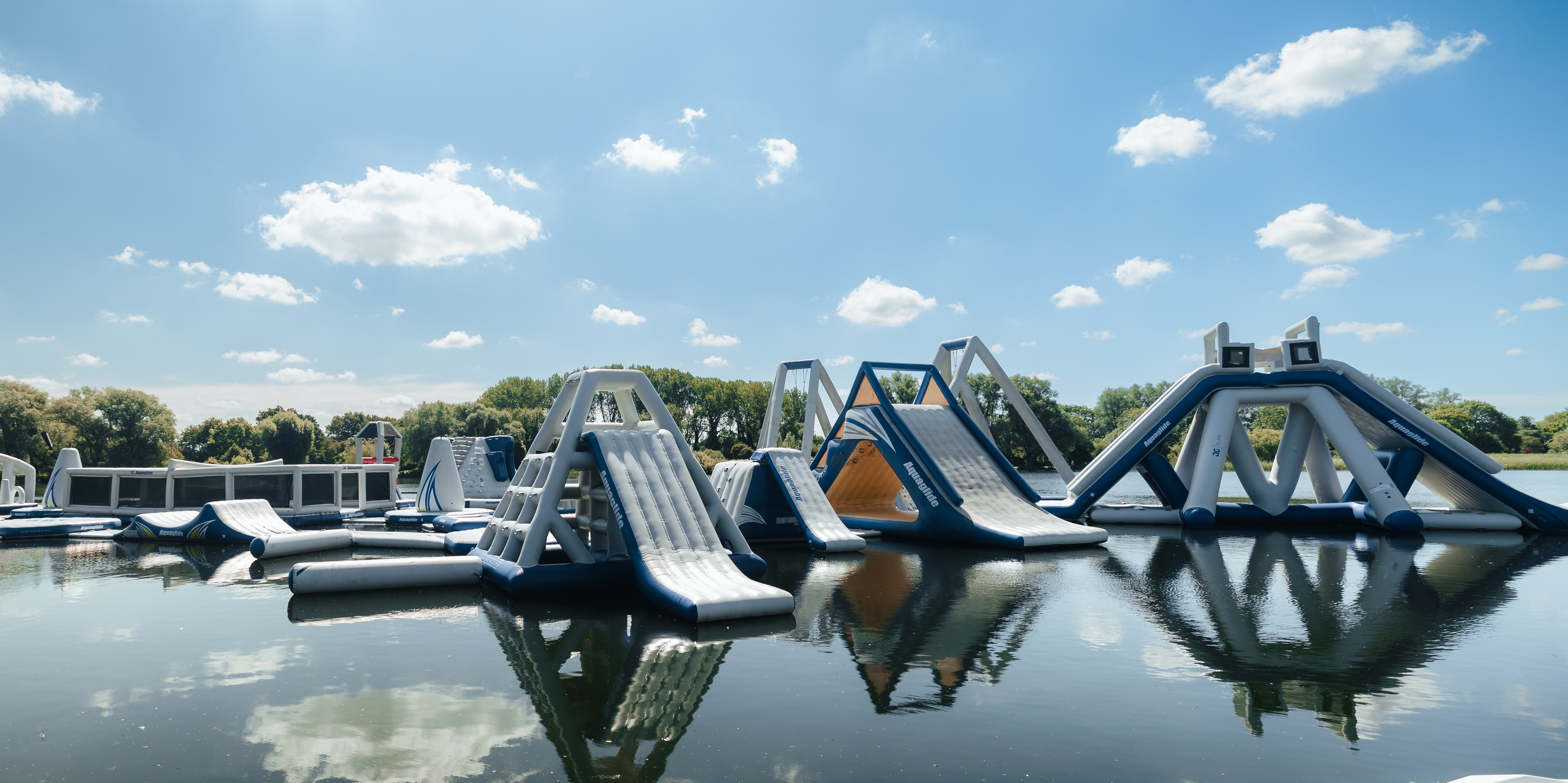 inflatable water park with slides on calm lake