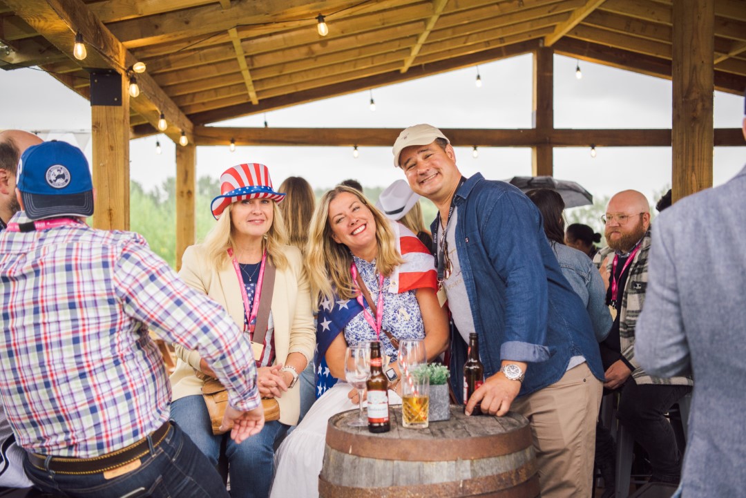 group of people enjoying drinks under wooden shelter at outdoor