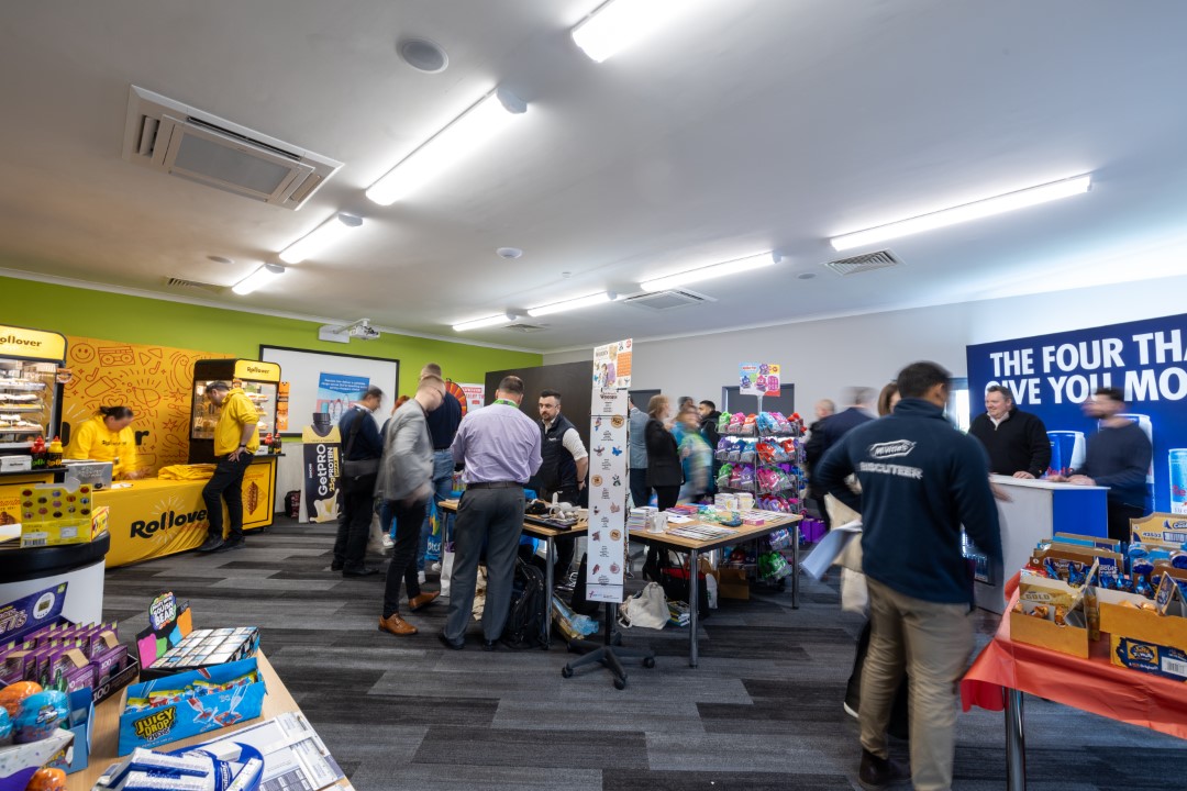people browsing stalls at an indoor market event