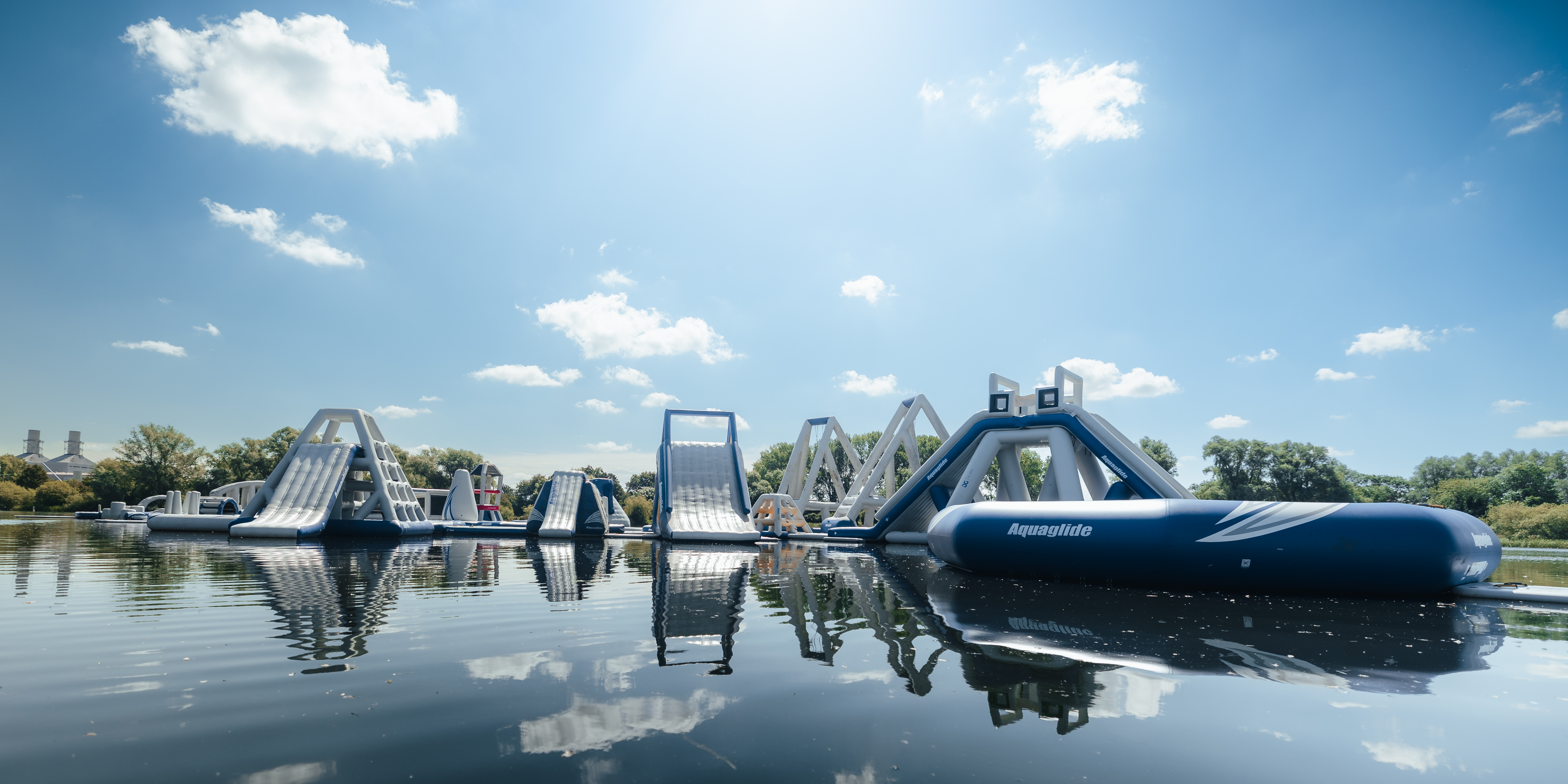 inflatable water park on lake under blue sky
