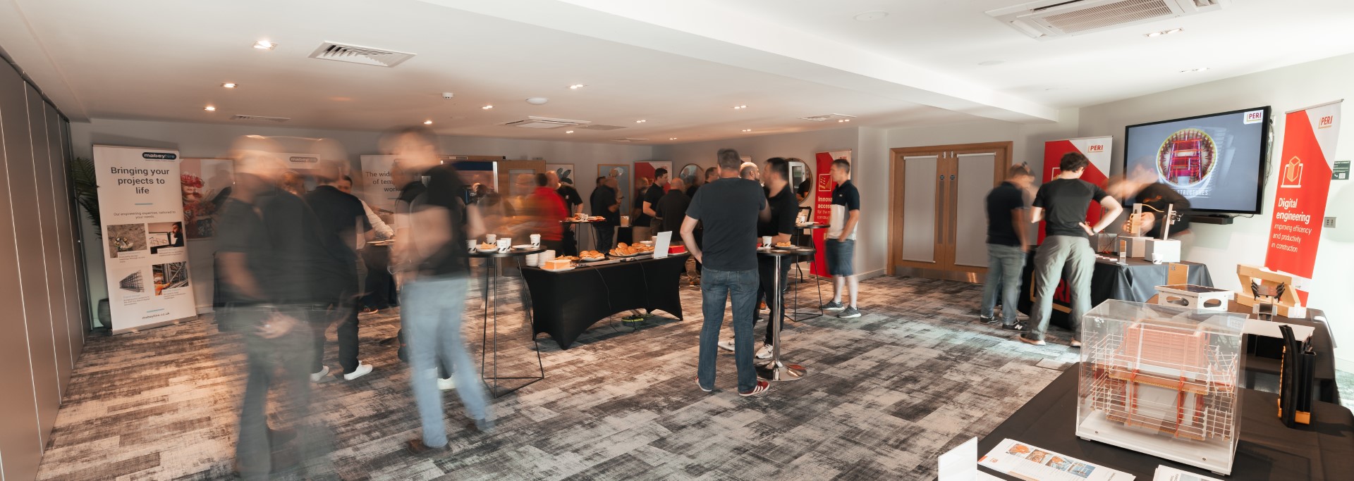 people networking at indoor exhibition with display tables