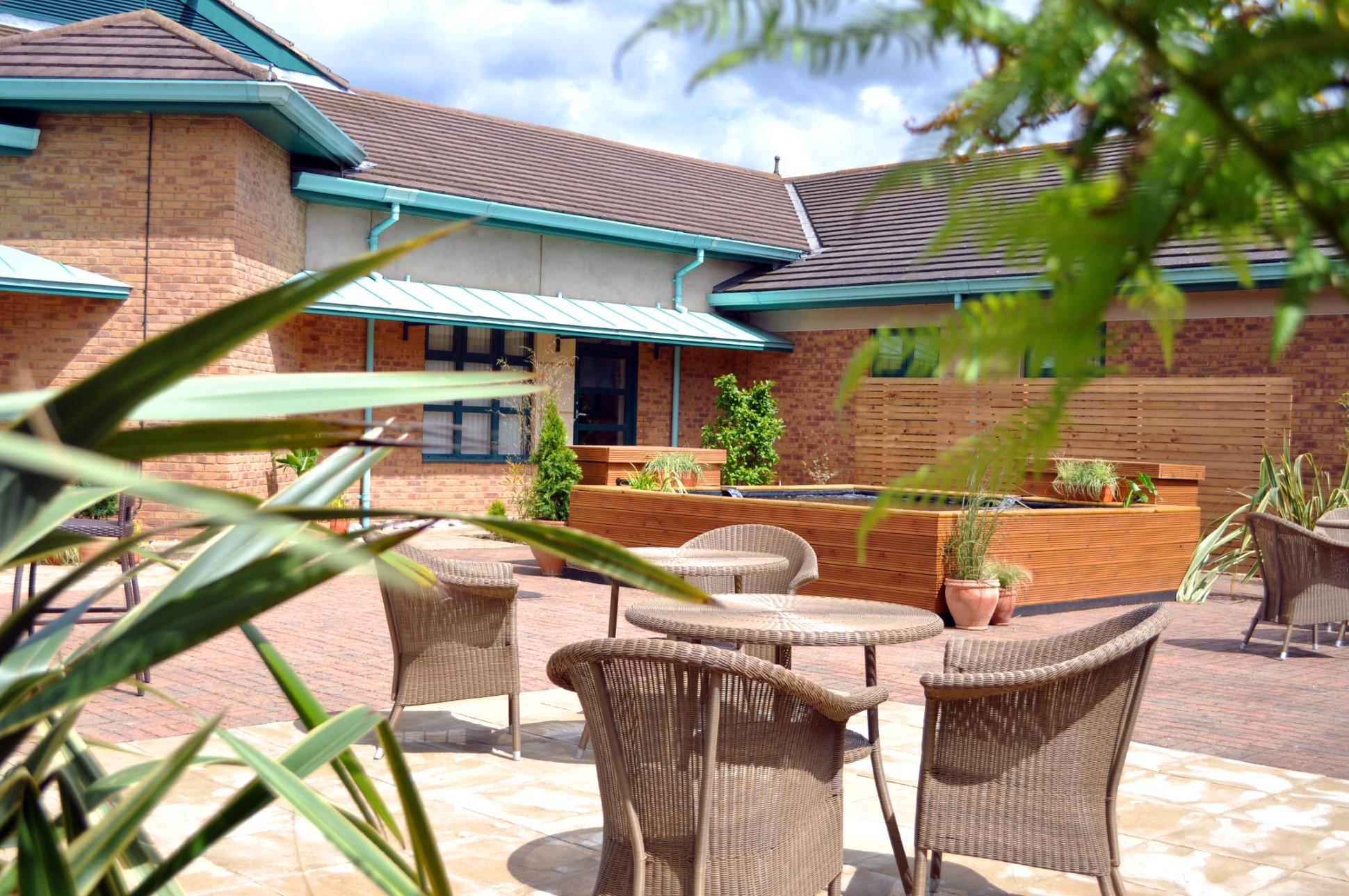quiet outdoor seating area with wicker chairs and tables