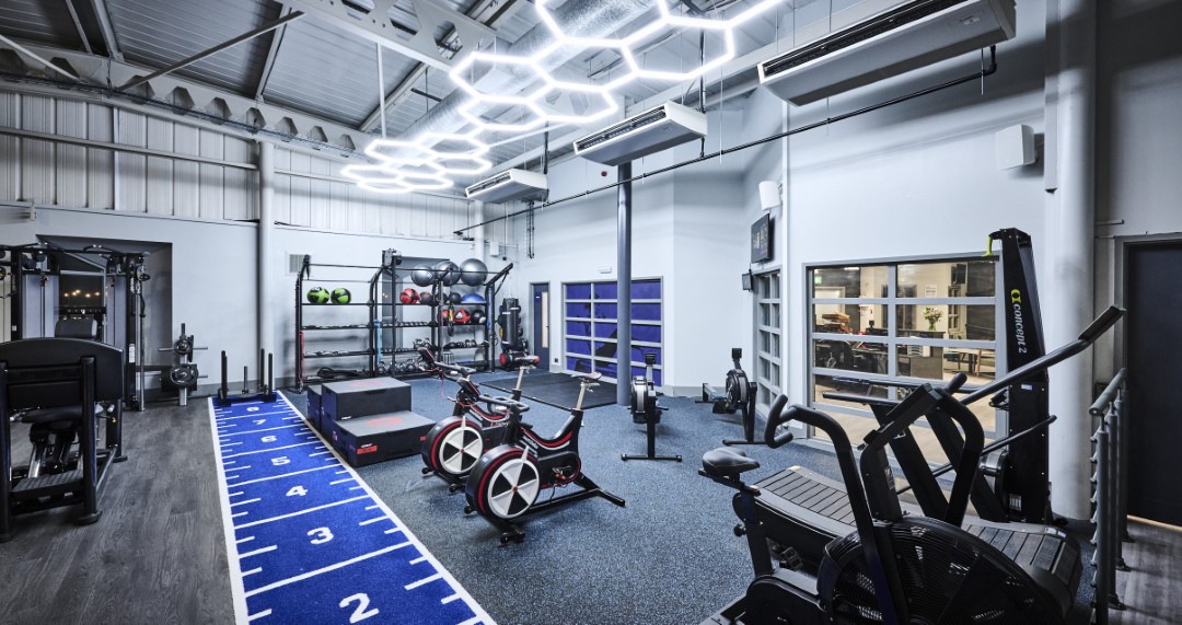 modern gym with exercise bikes and weights