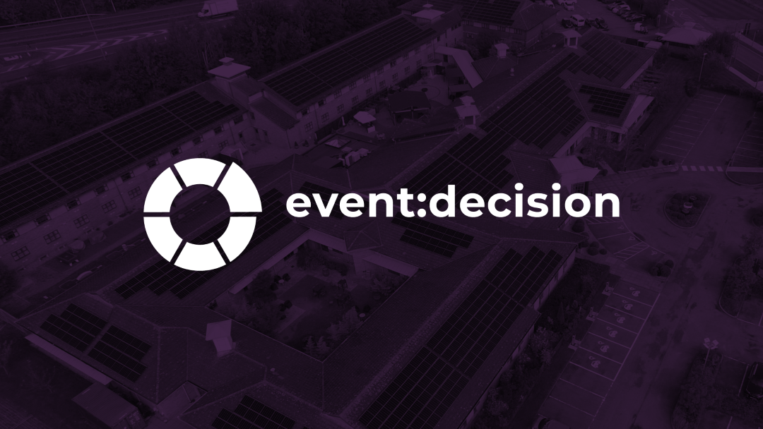 aerial view of a building with solar panels on roof