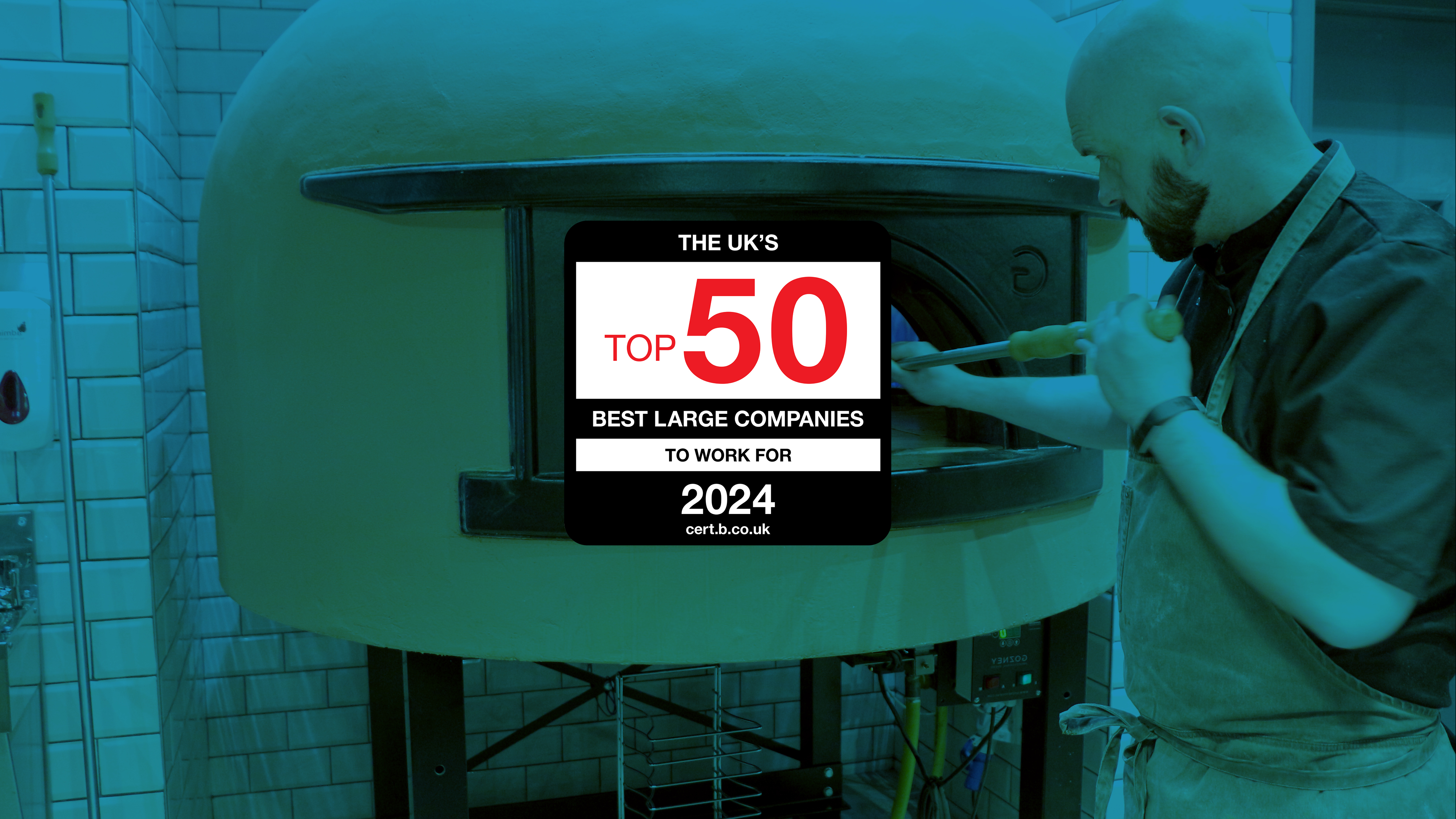 man using oven in commercial kitchen