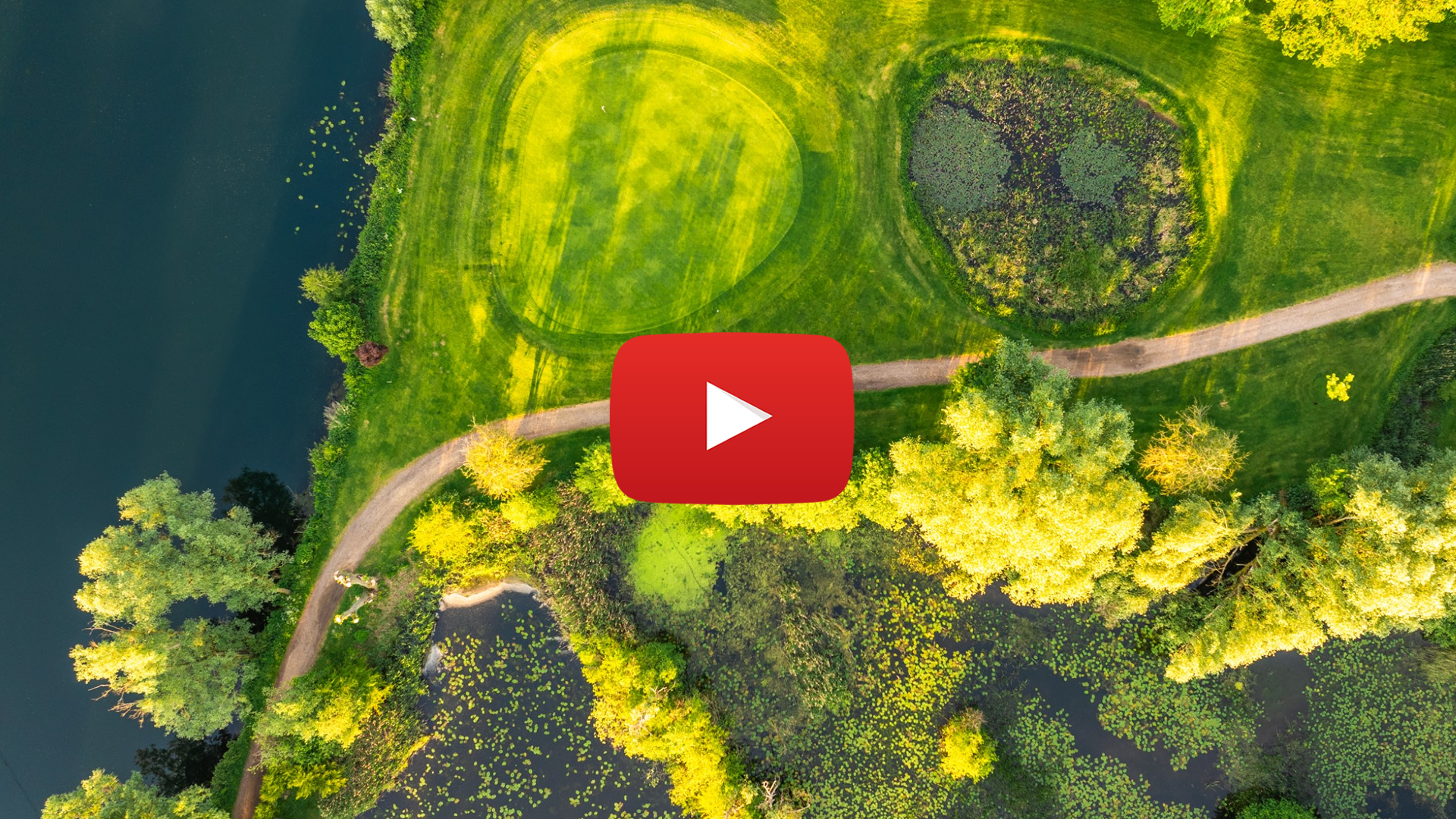 aerial view of lake grassy park and footpath