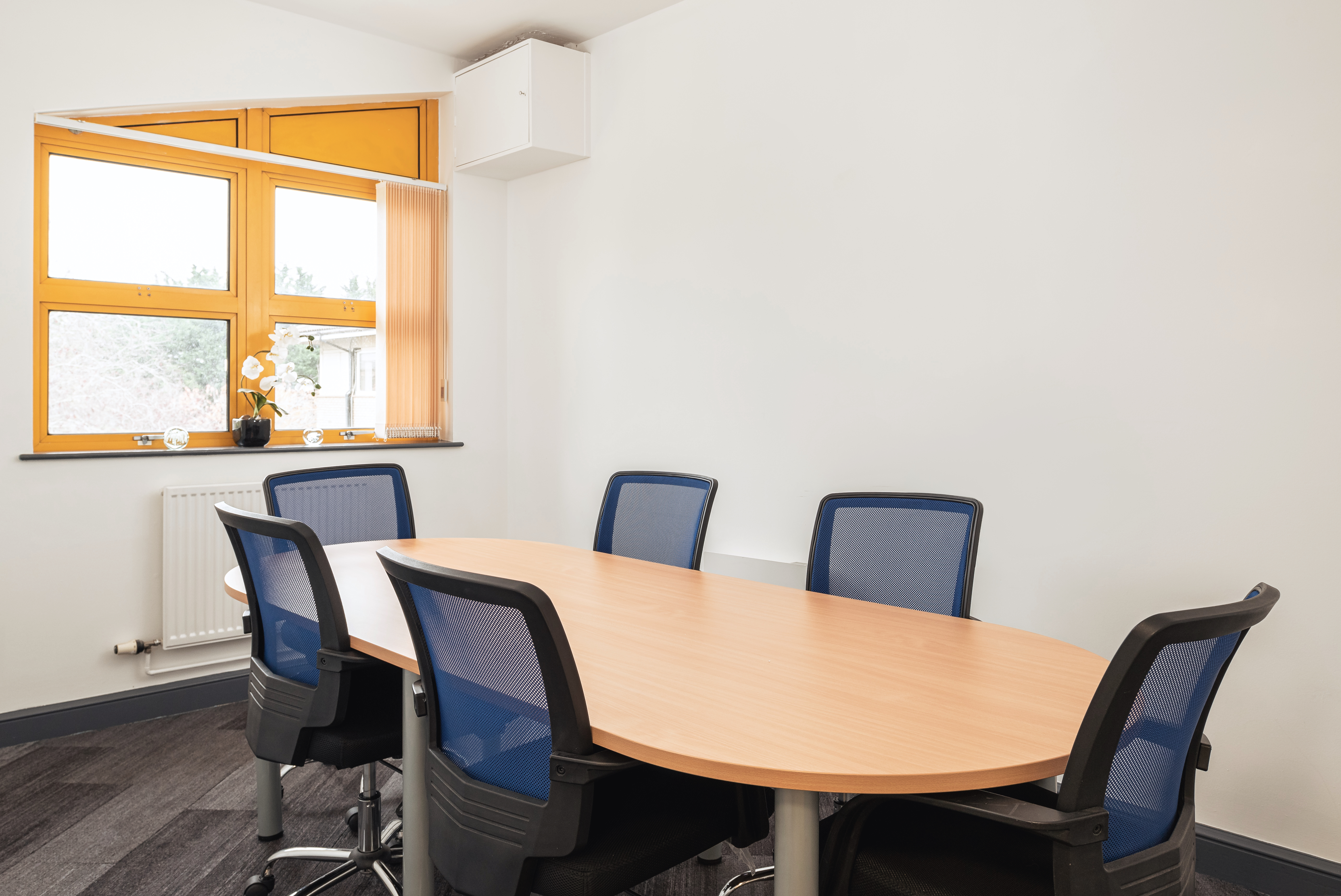 empty office meeting room with six chairs and wooden table